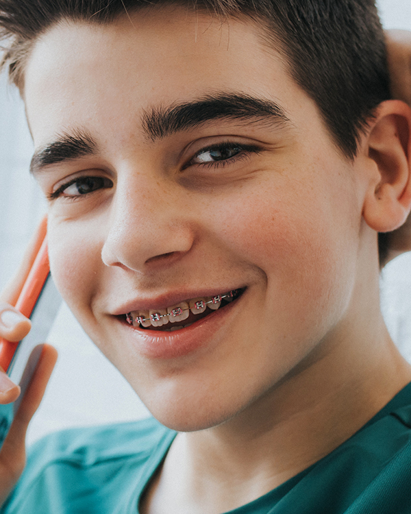 A patient of Allen & Allen Orthodontics on a cell phone.